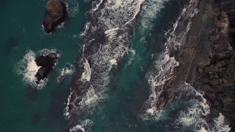 Top-down-aerial-Japanese-rock-islets-blue-water-waves-crushing-sea-Kyotango-kyoto-beach-japan-travel-destination