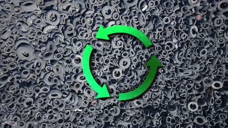 Aerial-of-green-rotating-recycle-sign-over-used-tires-junkyard-ready-for-recycling