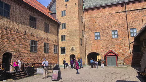 Oslo,-Norway,-People-on-Akershus-Fortress-Courtyard,-Walls-and-Tower-on-Sunny-Day