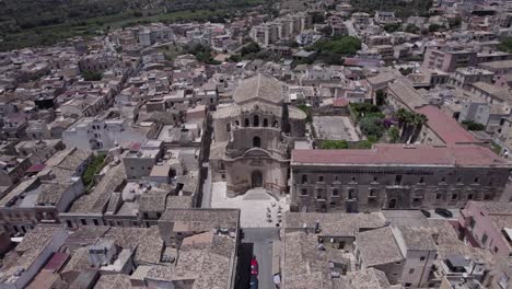 Aerial-orbit-historic-concave-facade-Madonna-Del-Carmine,-Noto-Sicily