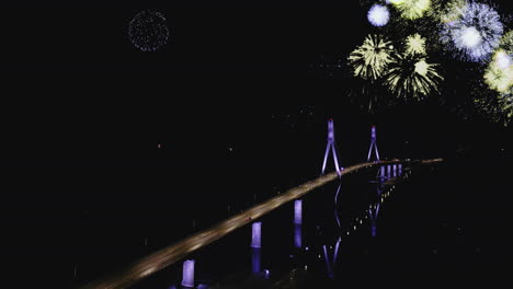 Festive-new-year-celebrations-above-illuminated-Replot-bridge-at-night,-Aerial