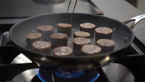 Cooking-And-Flipping-Blood-Sausage-In-Frying-Pan
