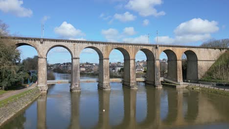 Drone-flying-at-low-altitude-towards-railway-bridge-in-Laval,-Mayenne,-France