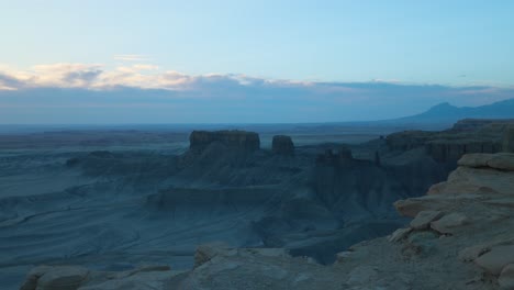 Panoramic-view-of-sunrise-desert-landscape-from-top-of-a-sandstone-butte,-Utah