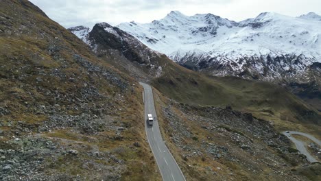 Tourist-Bus-Drive-Grossglockner-High-Alpine-Road-in-Austria-Alps---Aerial-4k-Follow
