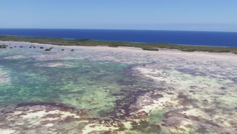 Lush-Aerial-view-boat-in-the-middle-of-nowhere,-surrounded-wetlands-los-roques-national-park