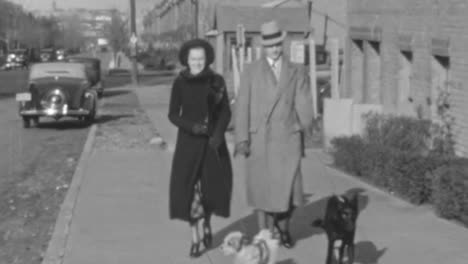 Couple-Walks-Down-Sidewalk-in-Neighborhood-with-Their-Dogs-in-New-York-1930s