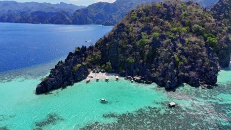 Distant-drone-footage-of-a-beach-with-boats-on-Coron-island-in-the-Philippines