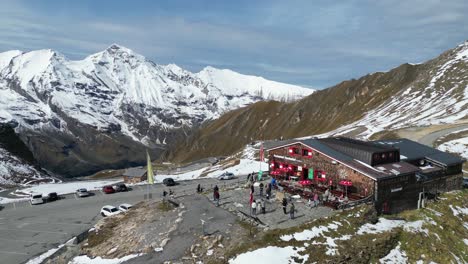People-enjoy-Panorama-View-at-Grossglockner-High-Alpine-Road-Restaurant-in-Austria-Alps---Aerial