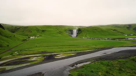 4K-drone,-aerial-cinematic-shots-of-wide-angle-green-landscape-in-Iceland-with-a-dramatic-cascades-of-waterfalls-in-the-middle