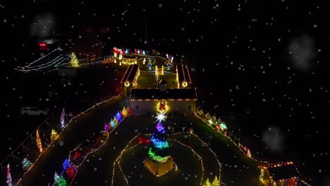 Snow-flurries-falling-on-Christmas-lights-walk-through-display-at-night