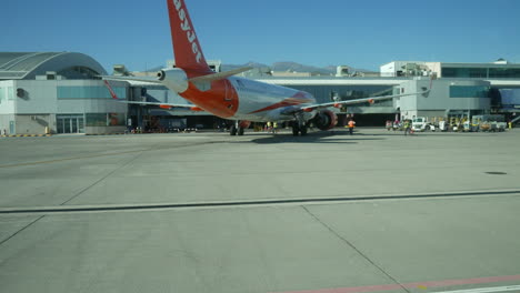 Travelling-along-the-runway-at-a-busy-airport-with-airliner-airplanes-on-the-tarmac-at-the-terminal-building