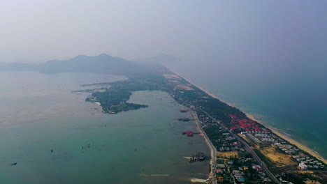 Scenic-high-aerial-view-flying-over-the-coast-of-Hoi-An,-Vietnam
