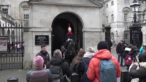 Tourists-take-pictures-with-a-Royal-Grenadier-Guard-along-Whitehall,-London