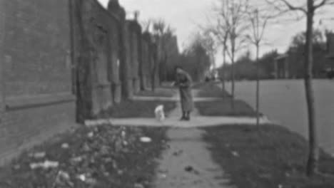 Dog-Runs-Happily-on-Sidewalk-During-Walk-with-Owner-in-Neighborhood-in-1930s