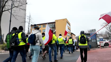 People-are-protesting,-the-crowd-is-walking-through-the-city-center