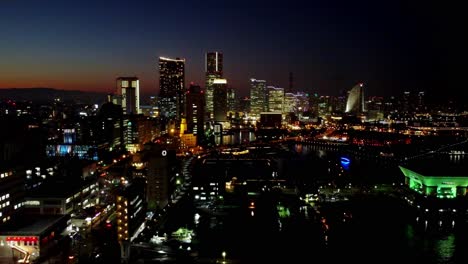 Twilight-cityscape-with-lit-skyscrapers-under-a-fading-sky,-urban-evening-glow