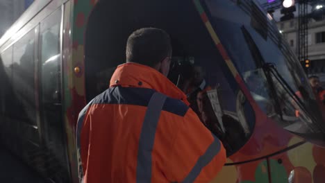 Slow-motion-shot-of-a-worker-using-a-walkie-talkie-speaking-with-tram-drivers