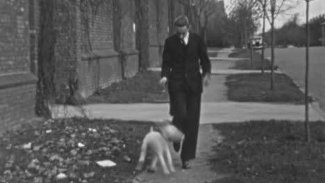 Young-Man-in-Suit-Walks-through-Neighborhood-with-Dog-in-1930s