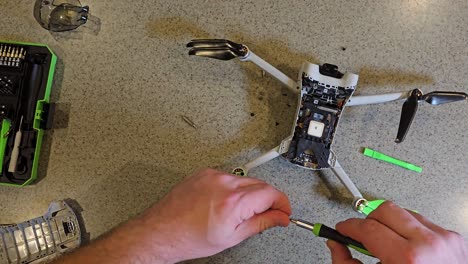Small-drone-being-repaired-viewed-from-overhead