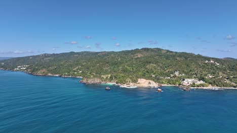 Aerial-flying-towards-La-Boca-del-Diablo-beach-on-sunny-day,-Dominican-Republic