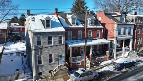 American-Homes-in-suburb-with-snow-with-ironman-with-parking-cars-during-sunny-day