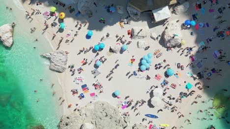 Crowd-of-People-Relaxing-on-Sunny-Beach,-Italy,-Overhead-Drone-View