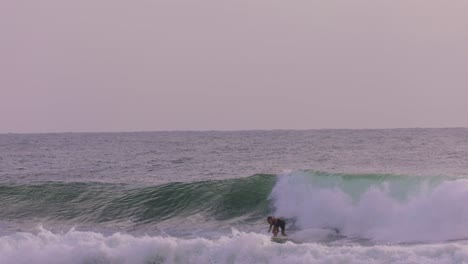 Morning-views-of-a-surfer-in-big-waves-at-Burleigh-Heads,-Gold-Coast,-Australia