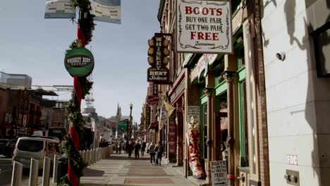 Tourists-on-Broadway-Street-in-Nashville,-Tennessee-during-the-day-with-wide-angle-in-slow-motion-stable