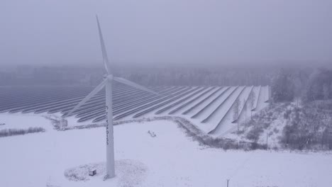 Drone-close-up-shot-on-wind-turbine-Tikupoiss-in-frosty-and-snowy-weather-producing-electricity