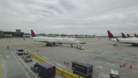 Delta-A321-Aircraft-being-pushed-back-onto-taxiway-between-terminal-T-and-A