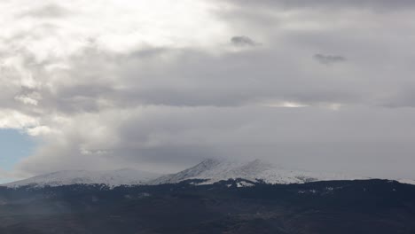 Berge-Zeitraffer-Von-Wolken,-Die-über-Den-Schneebedeckten-Berggipfel-Ziehen