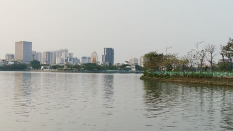 Tay-Ho-Lake-water-reflecting-back-city-buildings-and-shoreline-nature