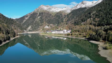 Water-Mirror-at-Lake-in-French-Pyrenees-Mountains,-France---Aerial-4k