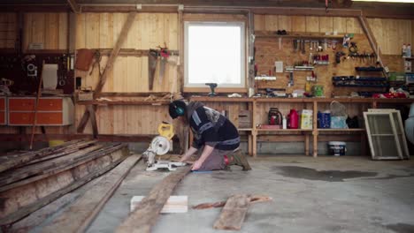 Timelapse-Of-A-Man-Using-An-Electric-Saw-To-Cut-A-Plank-Floor-Inside-The-Workshop