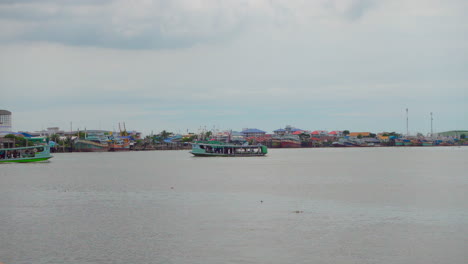 Traversing-the-Ta-Chin-River-in-Samut-Sakhon,-these-boats-gracefully-transport-passengers-across-the-river
