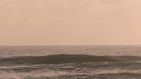 Surfer-getting-dumped-by-a-wave-at-Burleigh-Heads-at-sunrise,-Gold-Coast,-Australia