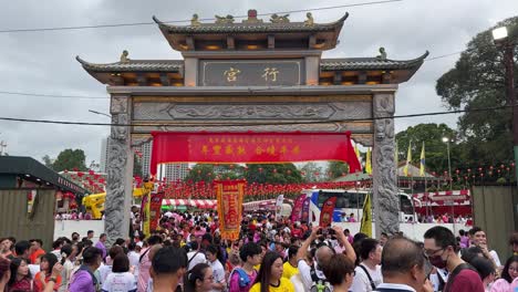 Devotees-happily-take-photos-and-videos-outside-Johor-Bahru-Old-Chinese-Temple,-'Xing-Gong'-Malaysia,-during-the-annual-tradition-of-Chingay