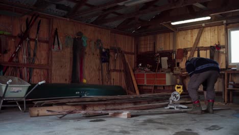 Scene-Of-A-Person-Inside-The-Shop-With-Wooden-Planks-And-Electric-Saw-Machine
