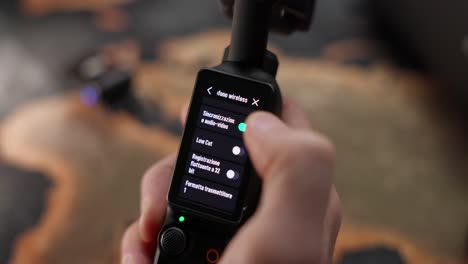 Photographer's-Thumb-Manually-Setting-Up-The-Settings-Of-Wireless-Mic-On-Pocket-Camera