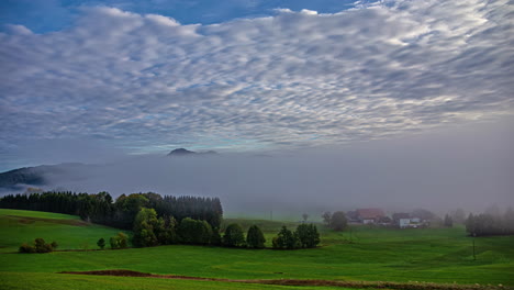 Vanishing-Fog---Town-And-Green-Meadow-Shrouded-By-Fog-In-The-Morning