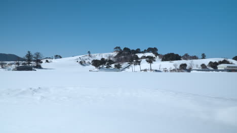 Wide-panning-view-of-scenic-winter-landscape-with-Clear-Blue-Sky-at-Daegwallyeong,-South-Korea