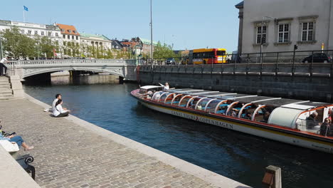 Everyday-Scene-in-Copenhagen,-Denmark,-Tourist-in-Boat-on-City-Sightseeing-Sailing-in-Canal