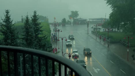 Cars-driving-up-scenic-tourist-location-Clifton-Hill-in-Niagara-Falls,-Ontario-on-a-very-rainy-and-overcast-day