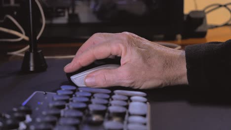 Closeup-of-male-hand-using-computer-mouse-at-home-desk