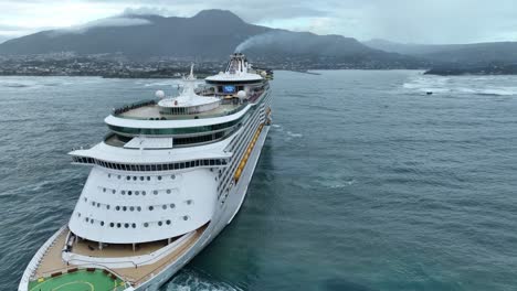 Royal-Caribbean-cruise-ship-navigating-in-open-ocean-close-to-coast-and-port-of-Puerto-Plata-in-Dominican-Republic