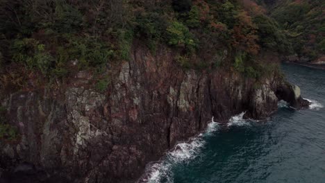 Aerial-Panoramic-Drone-Landscape-Rock-Cliff-Japanese-Sea-in-Kyoto-Kyotango-with-green-brown-orange-trees,-blue-ocean-waves-breaking-at-travel-Japan-Asian-destination