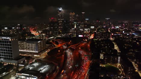 Downtown-Atlanta-cityscape-street-view,-modern-skyscrapers-and-skyline-buildings-at-night-under-cloudy-sky,-Georgia,-USA