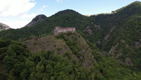 The-historic-poenari-citadel-amidst-lush-greenery,-aerial-view