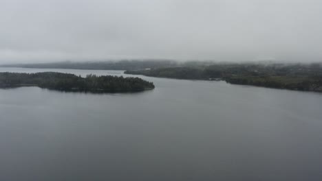 Foggy-calm-lake-in-Northern-Sweden,-Scandinavia